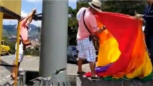 FOTO: Hombre baja y rompe la bandera del orgullo gay