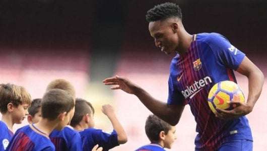 Foto: Yerry Mina saluda a varios niños culés en su presentación en el Camp Nou de Barcelona - EFE